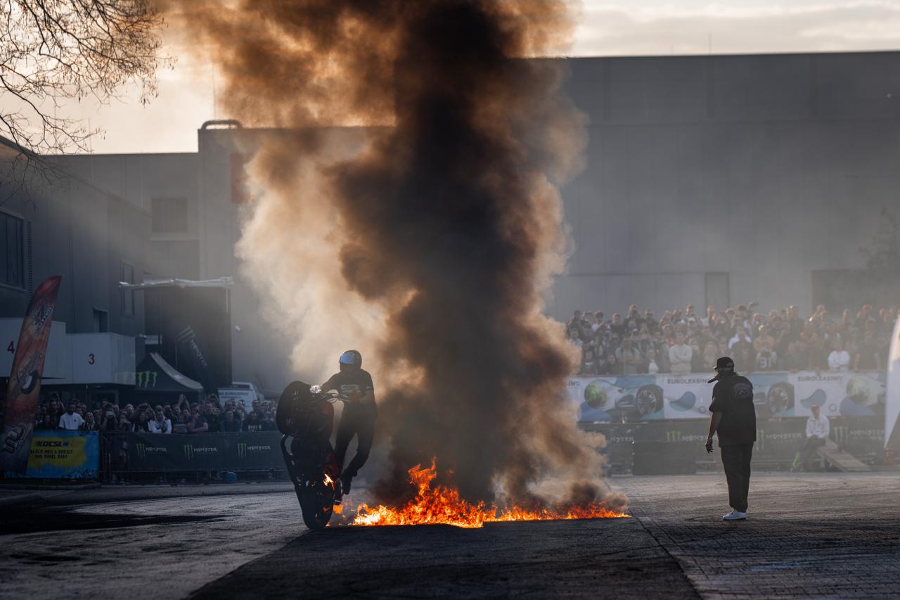 Motorcycle rider doing burnout through fire wall at Monster Energy outdoor event