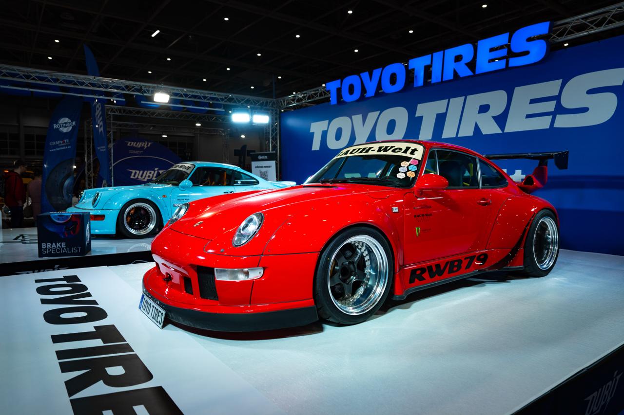 Red and blue Rauh-Welt Begriff Porsche 911s on the Toyo Tires exhibition stand at auto show